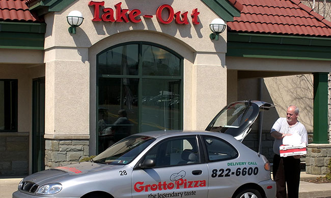 Photo of delivery driver, delivering pizzas